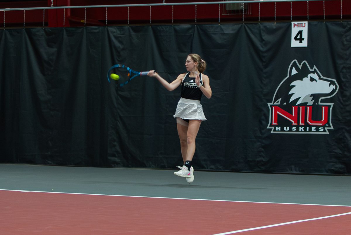 NIU women’s tennis senior Jenna Horne returns the ball to University of Wisconsin-Milwaukee sophomore Honoka Yamashita on Sunday in the Chick Evans Field House. NIU won the match against Milwaukee 6-1. (Aidan Penca | Northern Star) 