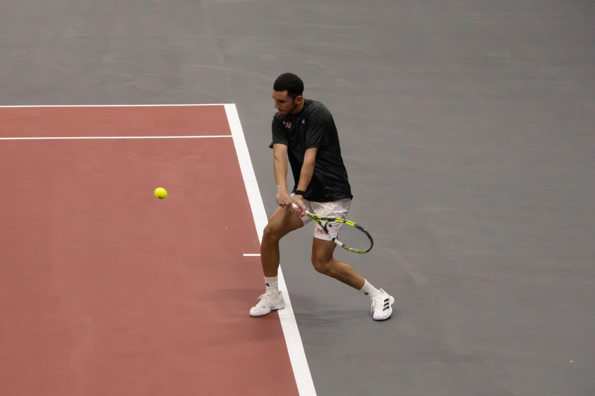 NIU men’s tennis senior Iker Dellien Velasco prepares to hit the ball during his singles match against Southern University and A&M College junior Gabriel Inyang on Friday in the Chick Evans Field House. The Huskies defeated the Jaguars 7-0. (Sanaa Scott | Northern Star)