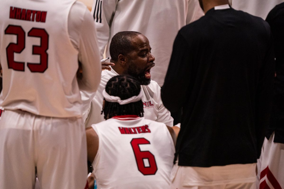 NIU men’s basketball head coach Rashon Burno gives a speech to his team during a timeout against Ohio University on Saturday in the Convocation Center. The Huskies were defeated 74-66 by the Bobcats. (Eric McGill | Northern Star)