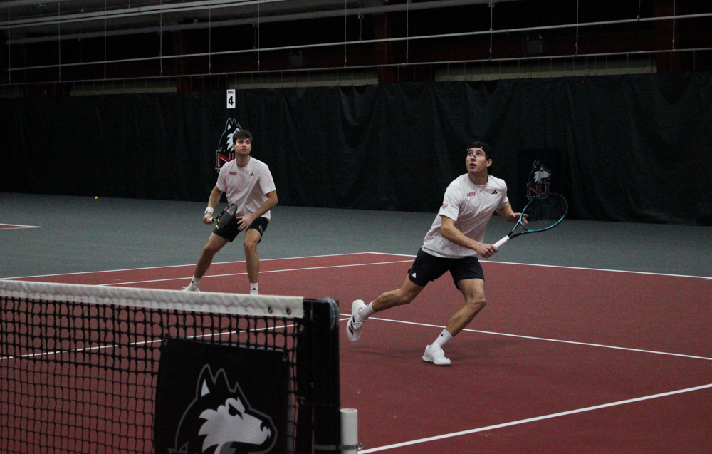 NIU men's tennis sophomore Nikola Puntaric rushes to hit the ball while senior Federico Scotuzzi stays back to defend against Roosevelt University's junior Demille Scarabello and senior Abhay Singh on Saturday in the Chick Evans Field House. The Huskies are now 3-1 overall. (Logan Reed | Northern Star)

