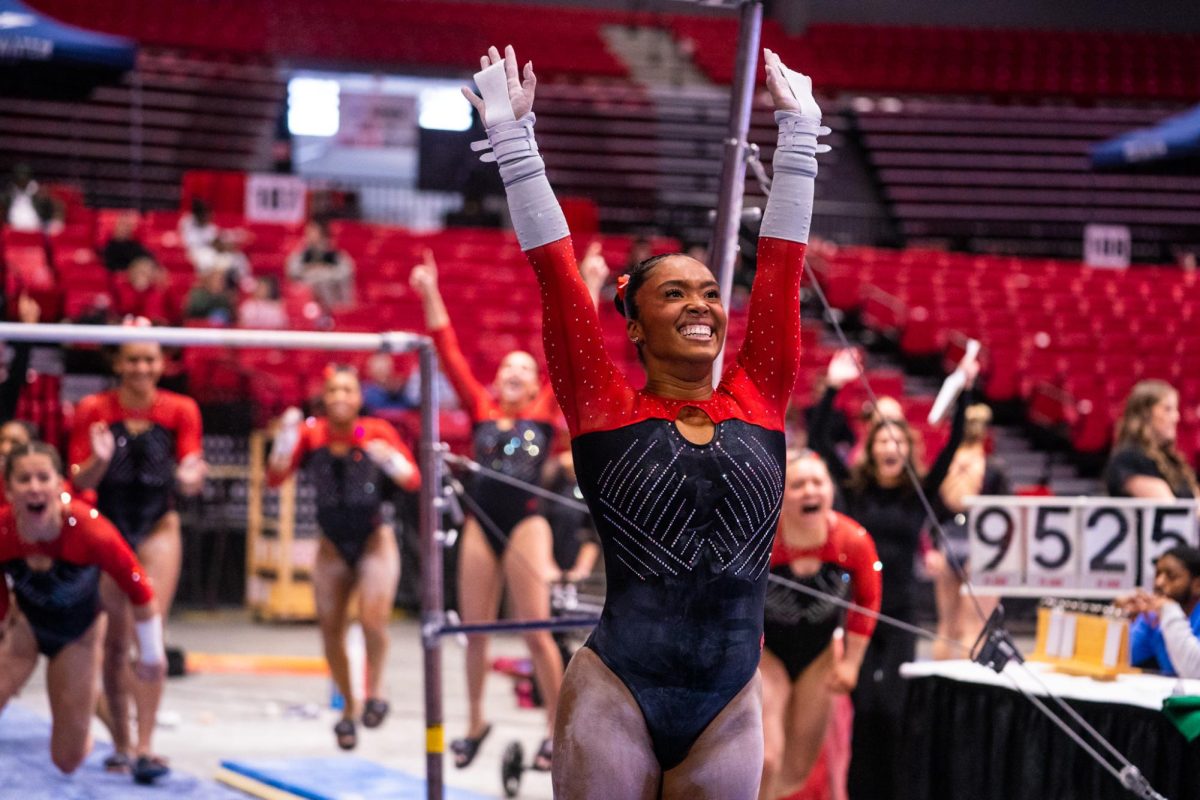 NIU women’s gymnastics sophomore Drake White smiles after her first attempt on the bars during the meet against the University of Wisconsin-La Crosse on Sunday at the Convocation Center. The Huskies won the meet by a score of 193.000-191.400. (Eric McGill | Northern Star)
