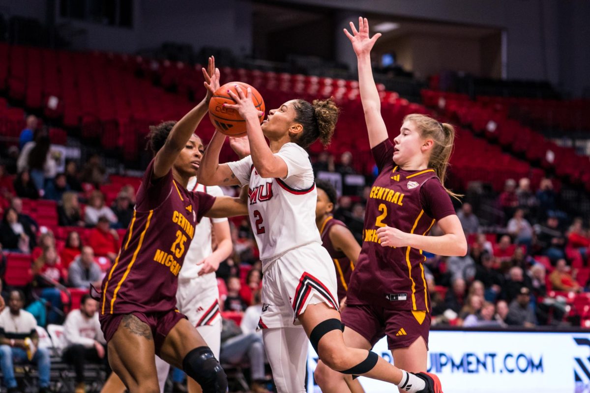 NIU women’s basketball graduate guard Nadechka Laccen (2) shoots a contested layup over Central Michigan University defenders during Saturday’s game in the Convocation Center. Laccen played all 40 minutes for NIU, putting up 17 points in the Huskies’ 75-70 loss.  (Eric McGill | Northern Star)