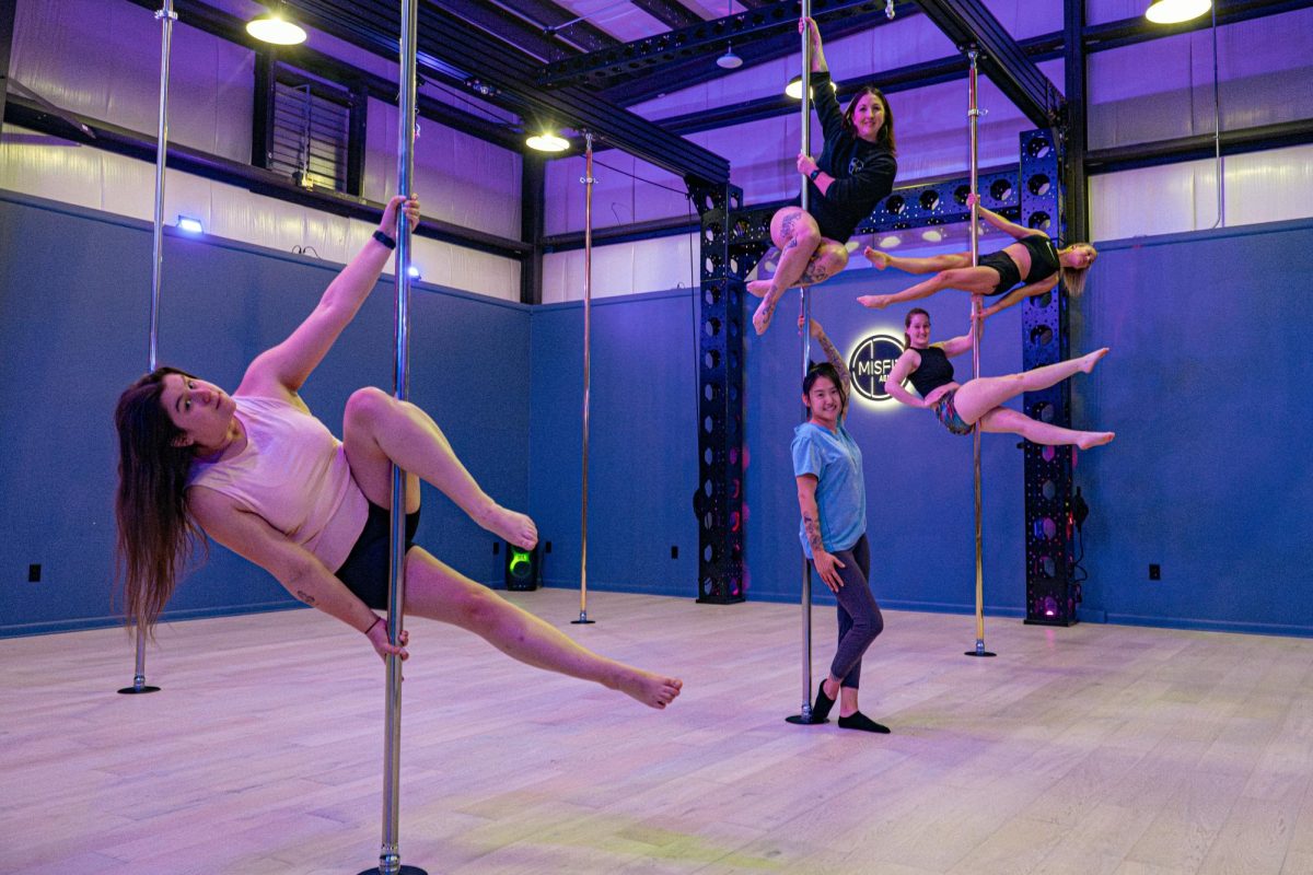 Members and workers of Misfit Arial, LLC, pose on poles at 2057 Albright Road in Montgomery. Pole dancing can be done as an exercise to help with cardiovascular endurance, muscular strength and flexibility. (Totus Tuus Keely | Northern Star