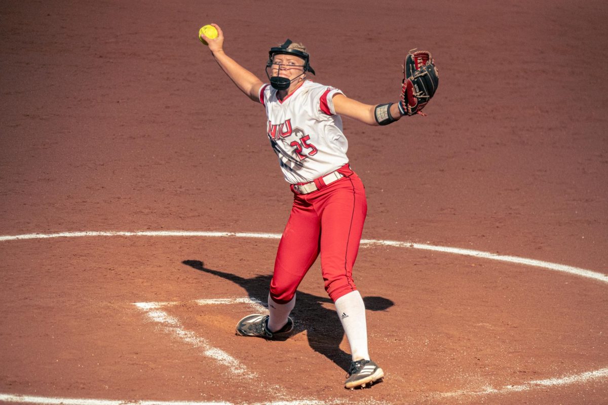 
NIU softball graduate student pitcher Madison Carlson winds up to throw a pitch during the Huskies’ game against Triton College on Sept. 12. The Huskies split their opening day double header with a win against Abilene Christian University and a loss to Ohio State University. (Totus Tuus Keely | Northern Star)