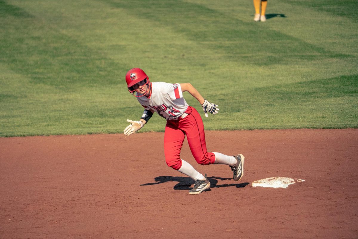 NIU softball freshman outfielder Izzi Hanna takes a lead off second base during the Huskies' game against Triton College on Sept. 12. NIU fell to the reigning national champions, the University of Texas Longhorns, in a 9-1 loss on Sunday. (Totus Tuus Keely | Northern Star)