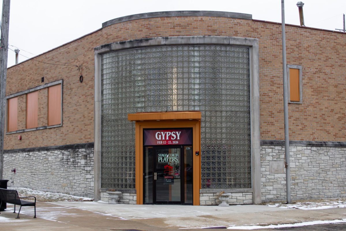 An advertisement for the showing of “Gypsy” is displayed above the front door of The Stage Coach Theater, 126 S 5th St. “Gypsy” will begin showing on Feb. 12 and run until Feb. 22. (Ethan Rodriguez | Northern Star)
