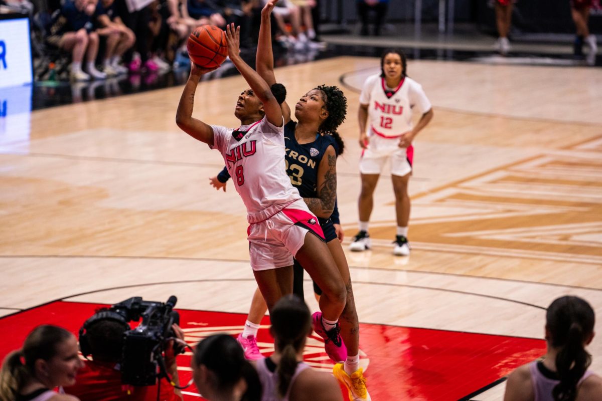 NIU women’s basketball junior forward Nevaeh Wingate (8) goes up for a layup during the Huskies’ game against Akron University on Saturday in the Convocation Center. NIU lost to the Zips in overtime, falling 75-68. (Eric McGill | Northern Star)