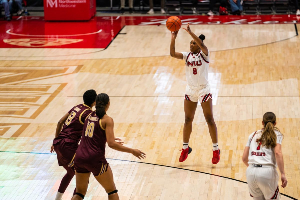 NIU women’s basketball junior forward Nevaeh Wingate (8) shoots a three-pointer early in the Huskies’ game against Texas State University on Saturday in the Convocation Center. Wingate co-led the Huskies on Saturday with 21 points in NIU’s 71-69 victory. (Eric McGill | Northern Star)