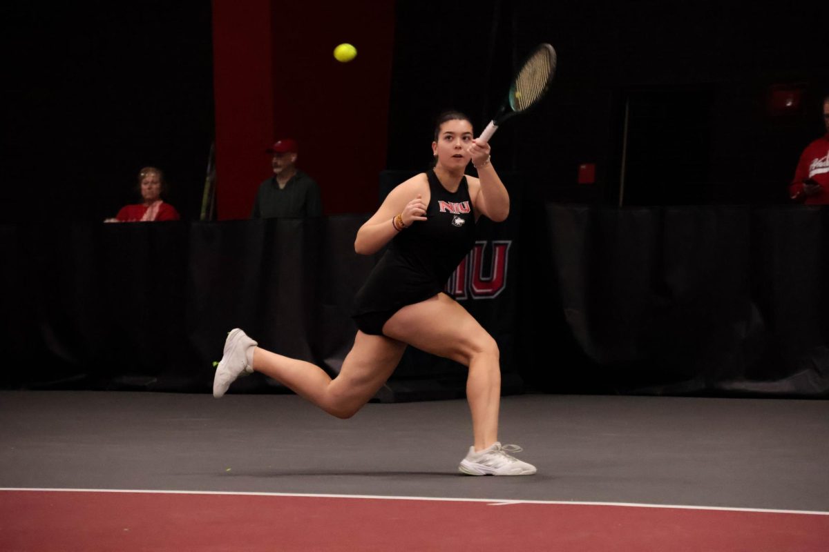 NIU women’s tennis sophomore Theodora Kousiou lunges to return a point in her doubles match against Saint Louis University on Sunday in the Chick Evans Field House. Kousiou and senior Jenna Horne won their doubles match against Saint Louis University freshman Naima Luthra and sophomore Aryn Walker 6-1. (Jayce Pendergrass | Northern Star)