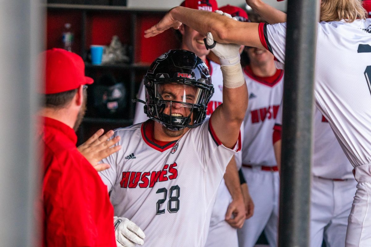 NIU baseball senior catcher Ivan Dahlberg wears an NIU football helmet after hitting his first home run of the game in the bottom of the fifth inning to tie the game against Miami University at Ralph McKinzie Field at Walt and Janice Owens Park. Dahlberg was the only Huskie with a multi home run performance on Friday, co-leading the team with 5 RBIs as well. (Eric McGill | Northern Star)