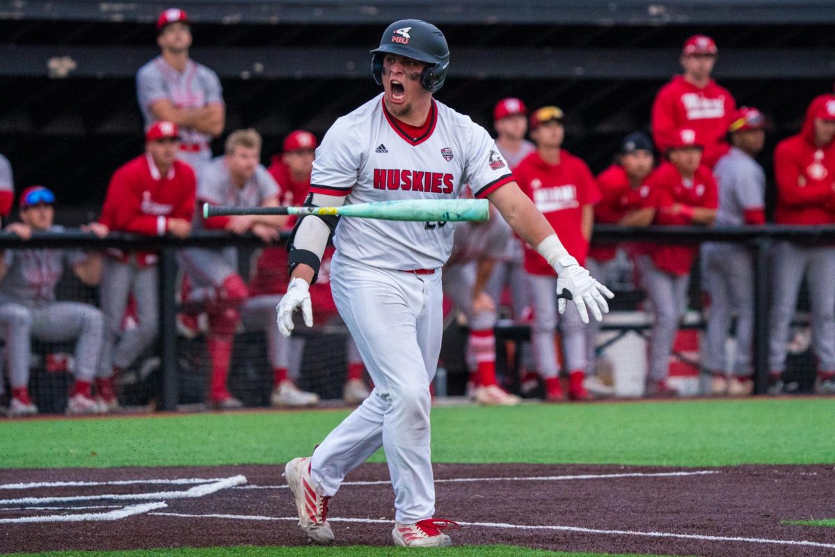 NIU baseball senior catcher Ivan Dahlberg flips his bat after hitting a walk-off grand slam against Miami University on Friday at Ralph McKinzie Field. The Huskies defeated the RedHawks 17-13 in a 10-inning game. (Eric McGill | Northern Star)