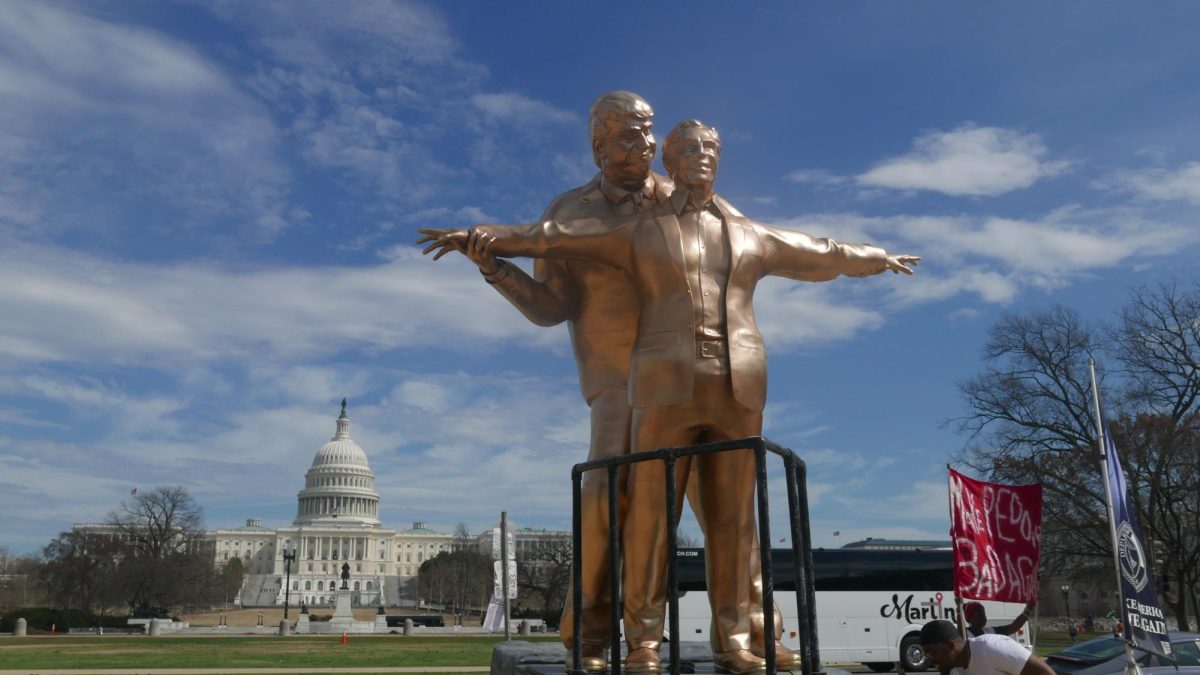 A large golden statue of President Donald Trump and Jeffrey Epstein, in the iconic “Titanic” pose, stands on March 11 outside the U.S. Capitol in Washington, D.C. The statue was anonymously dropped off in front of the Capitol as a way of protesting the administration. (Lupita Diaz | Northern Star)