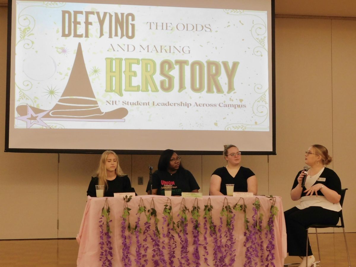 Graduate Research assistant for women and gender programming Chloe Steffel (right) introduces the panelists from Women and Gender Advocacy Alliance, Black Student Union and Prism at the DEFYING the odds and making HERStory panel with the Gender and Sexuality Resource Center and Academic Diversity, Equity and Inclusion on Tuesday in the Holmes Student Center, Regency Room. The GSRC’s next event is the Period Project and Give or Take Day on from 8:30 a.m. to 4 p.m. Wednesday in Room 132 of the Peter’s Campus Life Building. (Sofia Howell | Northern Star) 