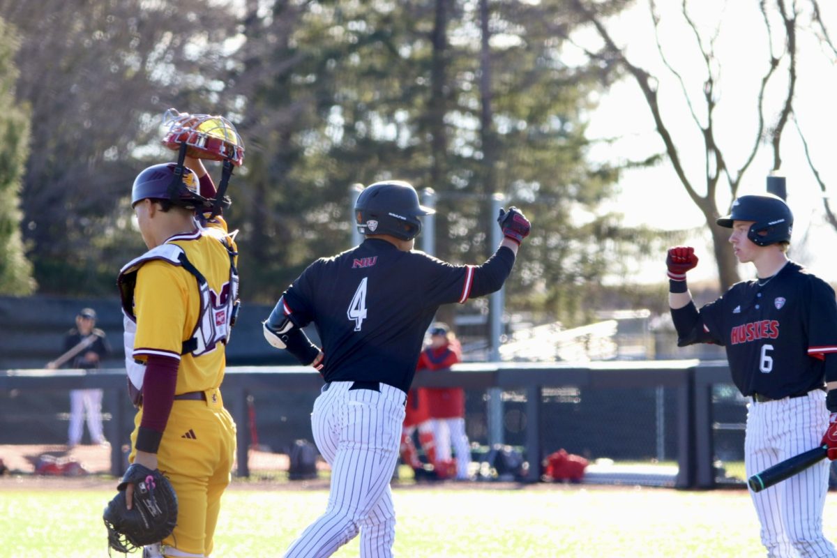 NIU baseball junior catcher Cooper Cohn (4) celebrates a run with sophomore infielder Nolan Sandee (6) during NIU’s game against Central Michigan University on March 22. The Huskies earned a series win over Lindenwood University after a 14-8 win over the Lions on Sunday. (Northern Star file photo)