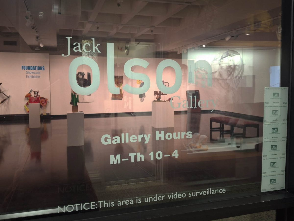 The Jack Olson Gallery sign is showcased on the glass outside of the gallery in the Art Building. The senior time arts majors are working with NIU administration to move their spring exhibition to a busier location instead of the Jack Olson Gallery. (Sanaa Scott | Northern Star)