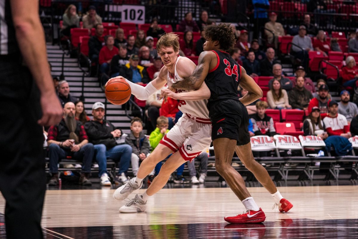 NIU men’s basketball freshman forward Gustav Winther drives against Ball State University freshman forward Preston Copeland (34) on Saturday in the Convocation Center. The Huskies earned their largest loss of this season, 79-43, against the Cardinals. (Eric McGill | Northern Star)