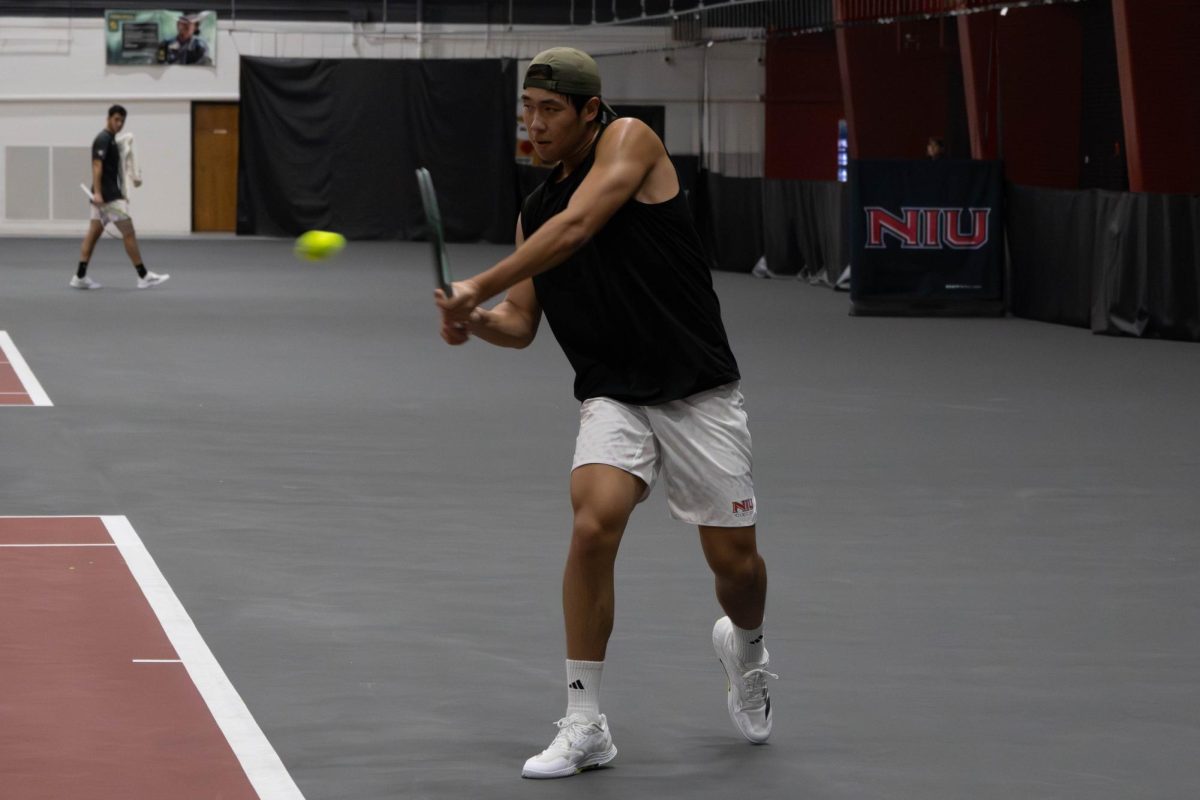 NIU men’s tennis sophomore Chiao Bo Suo Nan lunges towards the ball during his singles match against the University of Illinois Chicago sophomore Emil Dapcevic on Saturday in the Chick Evans Field House. Suo Nan defeated Dapcevic 6-3 and 6-2. (Sanaa Scott | Northern Star)