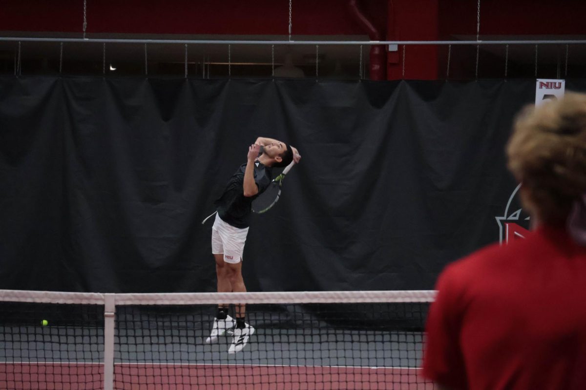 
 NIU men’s tennis senior Iker Dellien Velasco serves during his singles match against  Grinnell College senior Albert Bostoen on Sunday in the Chick Evans Field House. The Huskies swept the match in a 7-0 win, improving to 9-2 on the season. (Sanaa Scott | Northern Star)