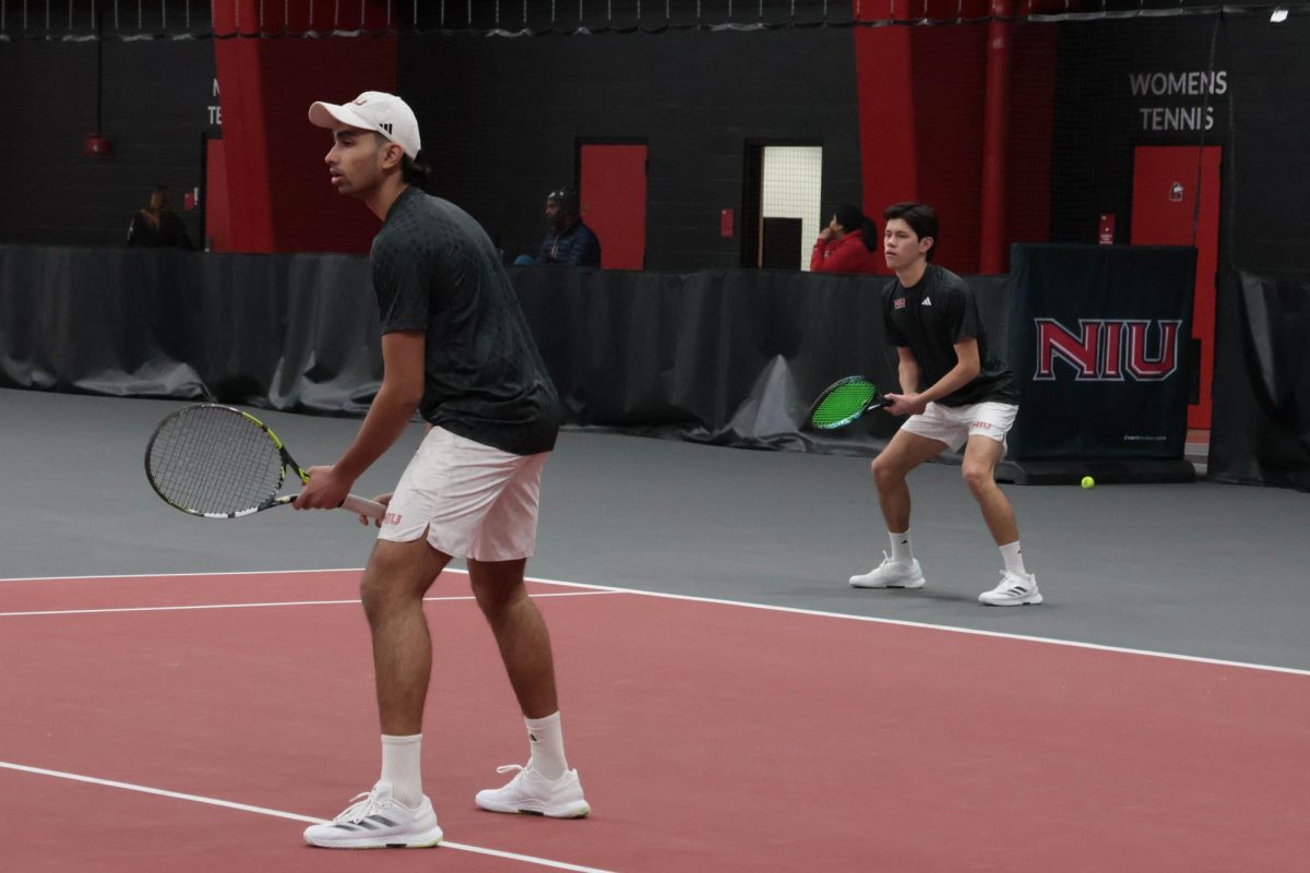 NIU men’s tennis sophomore Pratyaksh LNU (left) and sophomore Gustavo Juarez Lopez prepare to receive the ball while warming up for their match against Grinnell College on March 1. The Huskies took a 4-3 comeback win over Western Michigan University on Thursday, the first win for NIU over the Broncos since 2016. (Northern Star file photo)