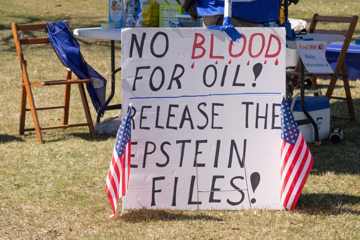 A poster reading “NO BLOOD FOR OIL! RELEASE THE EPSTEIN FILES!” is set out for the No Kings protest on Saturday at Hopkins Park, 1403 Sycamore Road. Protestors expressed their concern over U.S. military inolvement in Iran, the Epstein files, Immigrations and Customs Enforcement and President Trump’s policies. (Roshay Grant | Northern Star)