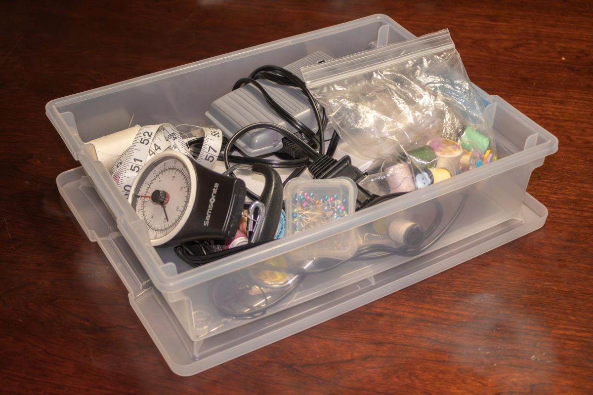 A box full of sewing supplies sits on a table. Opinion Columnist Adrian Maurer believes not every hobby should become a business. (Ethan Rodriguez | Northern Star)