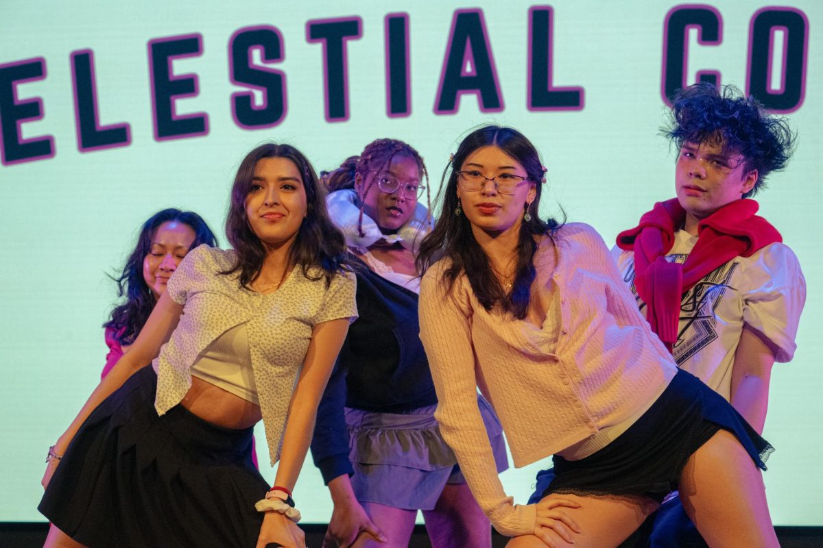 Members of Celestial Covers pose on stage during a performance at the Center Stage at Holmes Student Talent Show on Thursday in Holmes Student Center, Duke Ellington Ballroom. The event featured 12 NIU student acts, including dance, rap and vocal performances, as part of the second annual student talent show. (Totus Tuus Keely | Northern Star)