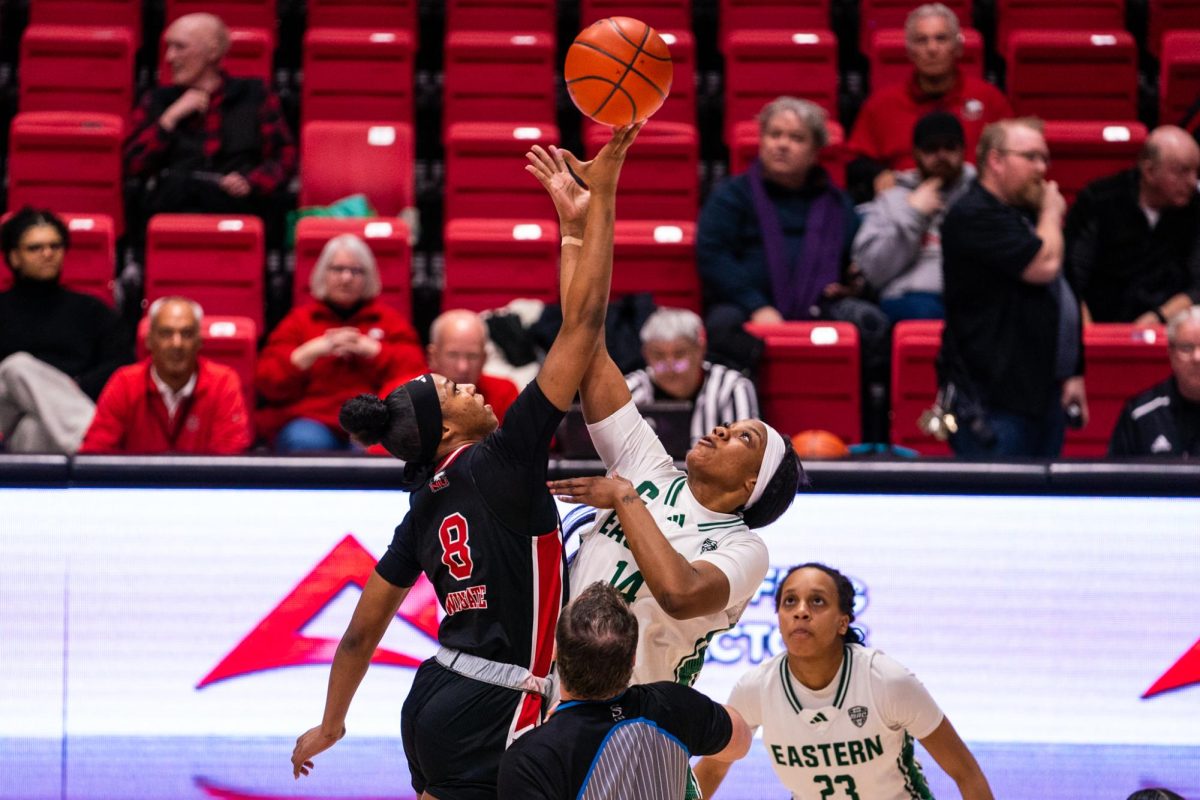 NIU women’s basketball junior forward Nevaeh Wingate (8) jumps for the tip off against Eastern Michigan University senior forward Sisi Eleko (14) on Saturday in the Convocation Center. The Huskies moved to 3-13 in Mid-American Conference play and 6-22 overall after the victory. (Eric McGill | Northern Star)