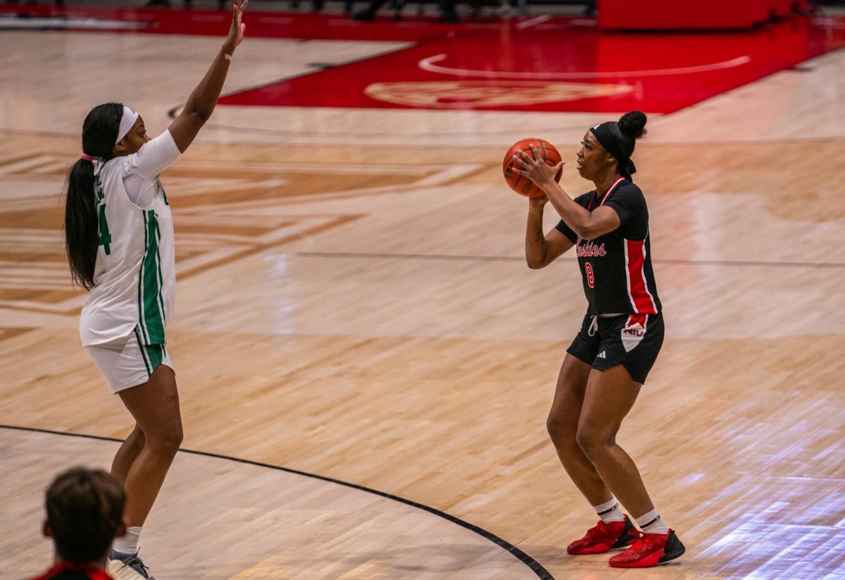 NIU women’s basketball junior forward Nevaeh Wingate (8) shoots a three-pointer against Eastern Michigan University on Feb. 28.  Wingate led the Huskies with 21 points as NIU lost its final game as a member of the Mid-American Conference, falling 77-66 to Bowling Green State University on Saturday. (Northern Star file photo)