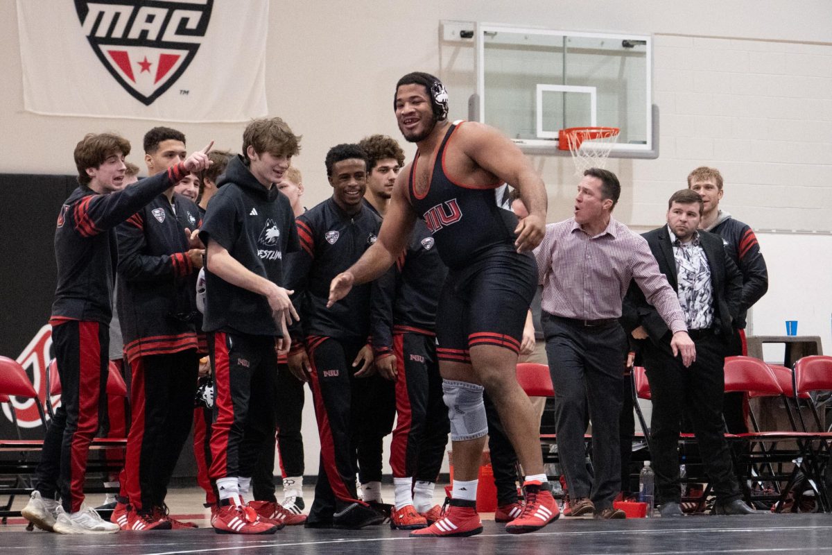 NIU wrestling graduate student Devon Dawson celebrates with teammates during the Huskies’ dual against Central Michigan University on Jan. 16. Dawson and redshirt junior Markel Baker competed at the NCAA Championships beginning on Friday. (Totus Tuus Keely | Northern Star)