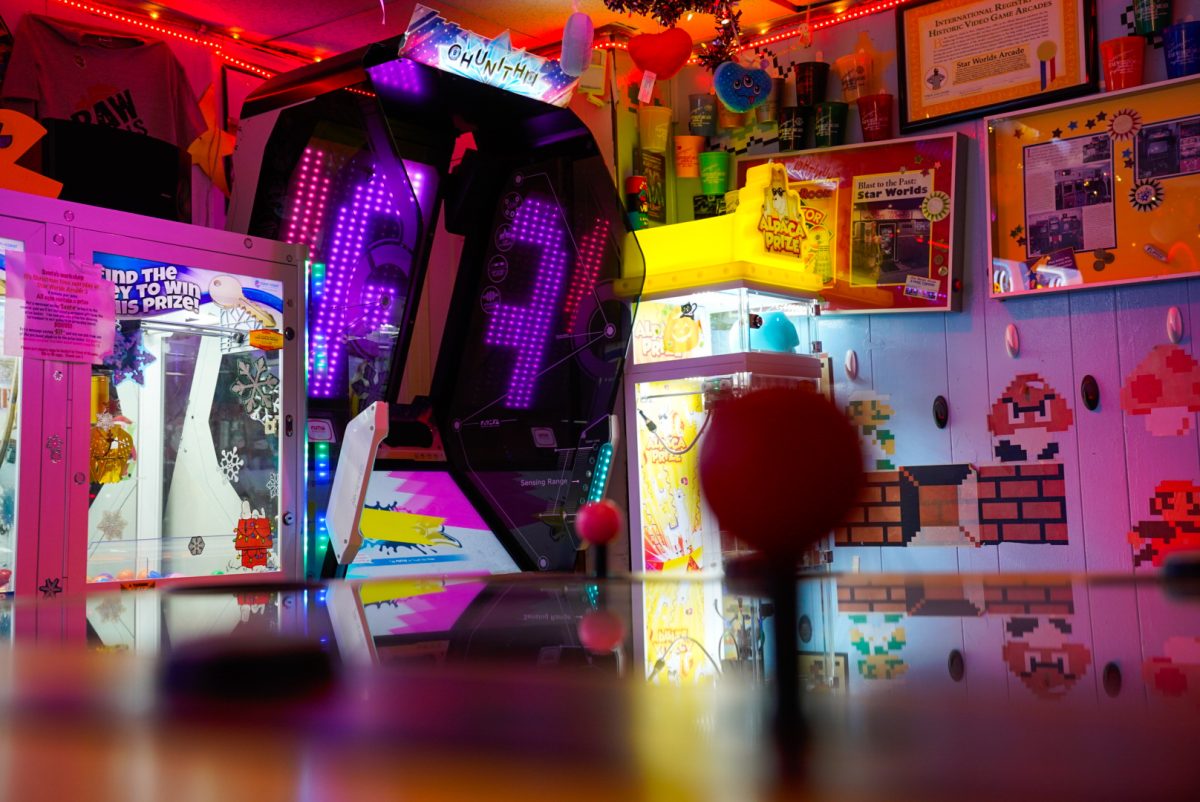 A variety of claw machines sit near a Mario-inspired wallpaper at Star Worlds Arcade, 1234 E. Lincoln Highway. The arcade is open from 3 p.m. to 10 p.m. Tuesdays through Thursdays, 3 p.m. to 11 p.m. Fridays, 11 a.m. to 11 p.m. on Saturdays, and noon to 8 p.m. on Sundays. (Ty McWilliams | Northern Star)