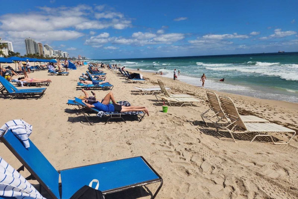 People lounge in the sun on March 17, 2023, on Fort Lauderdale Beach at Fort Lauderdale, Florida. Lifestyle Writer Zach Mueller shares his five tips for students wanting to visit Fort Lauderdale over spring break. (Sofia Didenko | Northern Star)