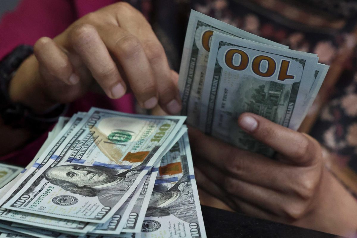 A teller counts U.S. dollar bank notes. Opinion Columnist Adrian Maurer believes influencers should not show off their wealth in their content. (Willy Kurniawan | Reuters)