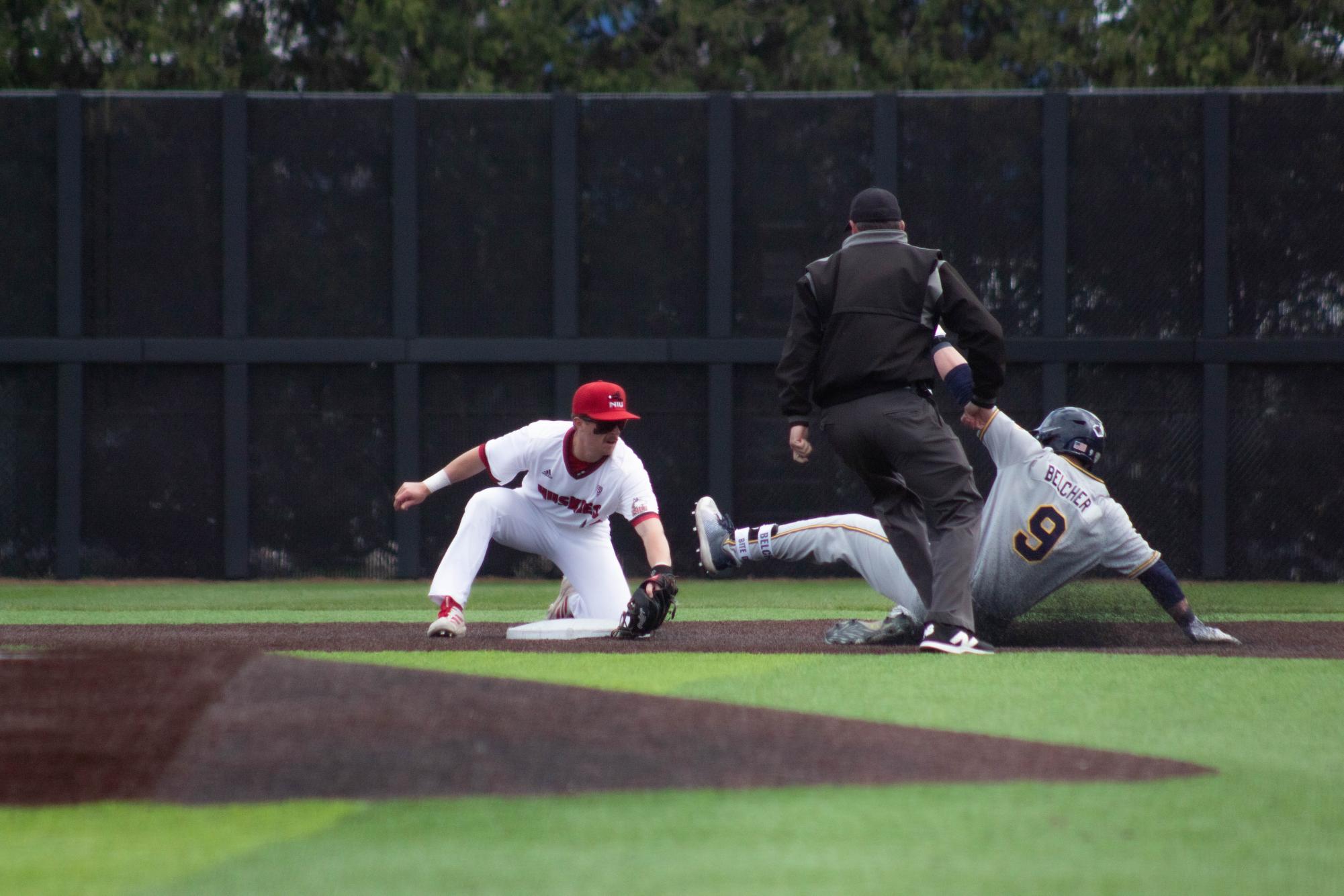 NIU baseball senior second baseman Cole Smith (left) lays down the tag at second base to cut off Kent State University’s redshirt freshman catcher Nolan Belcher for the out on Friday at Ralph McKinzie Field at Walt and Janice Owens Park. After Friday’s game, NIU is tied with Ball State for third place in the Mid-American Conference standings. (Jayce Pendergrass | Northern Star) 