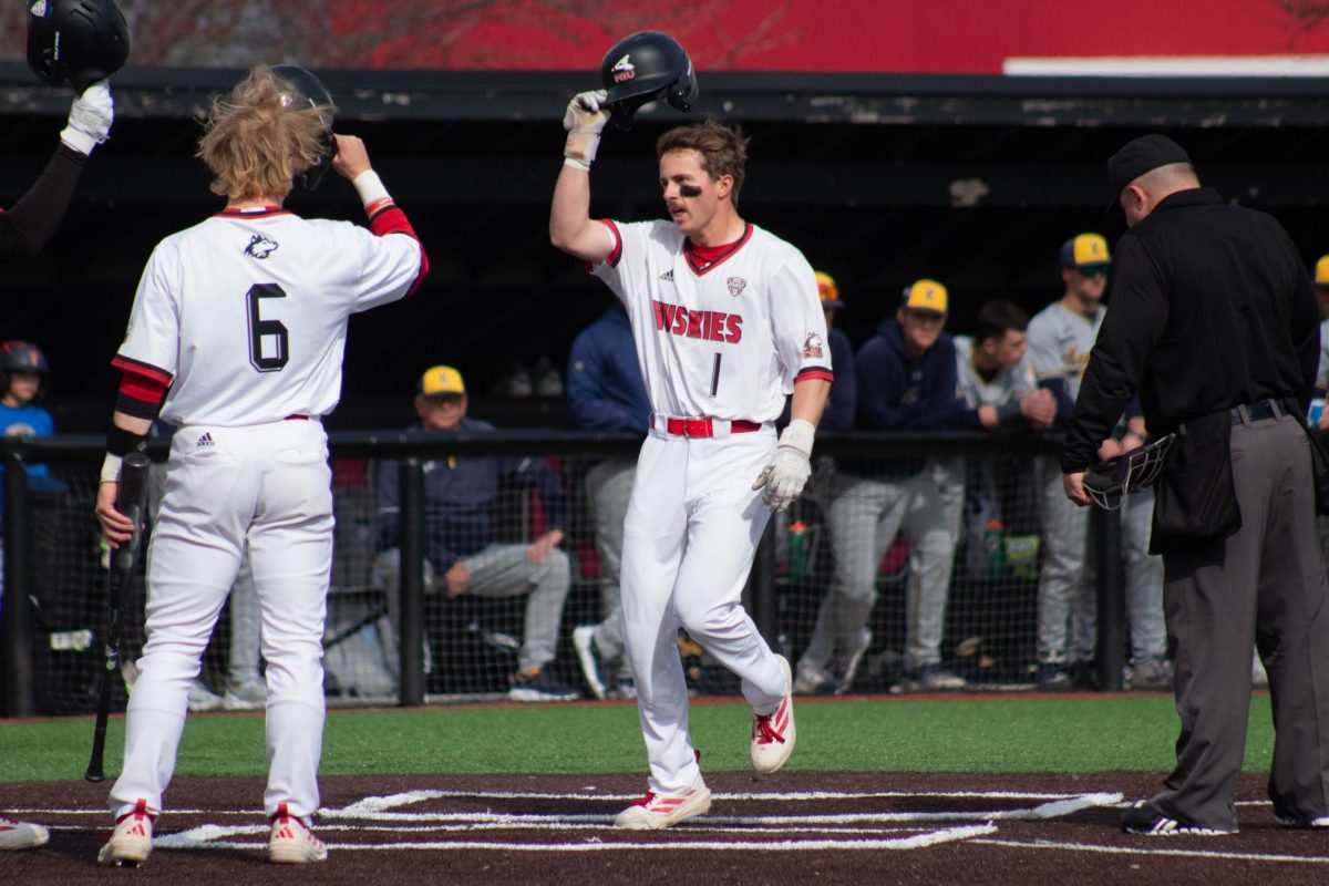 NIU baseball senior second baseman Cole Smith crosses home plate after hitting a three run home run against Kent State University on Friday. The Huskies took a 12-2 win over the Golden Flashes in seven innings, their first double-digit win of the season. (Jayce Pendergrass | Northern Star) 