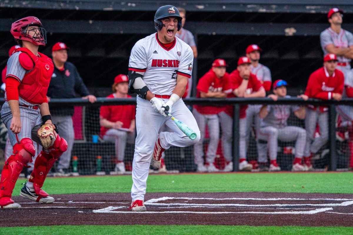 NIU baseball senior catcher Ivan Dahlberg screams with excitement right after making contact with his walk-off grand slam in the bottom of the 10th inning against Miami University on March 20. Dahlberg’s experience behind the plate has helped to revive NIU’s pitching. (Northern Star file photo)