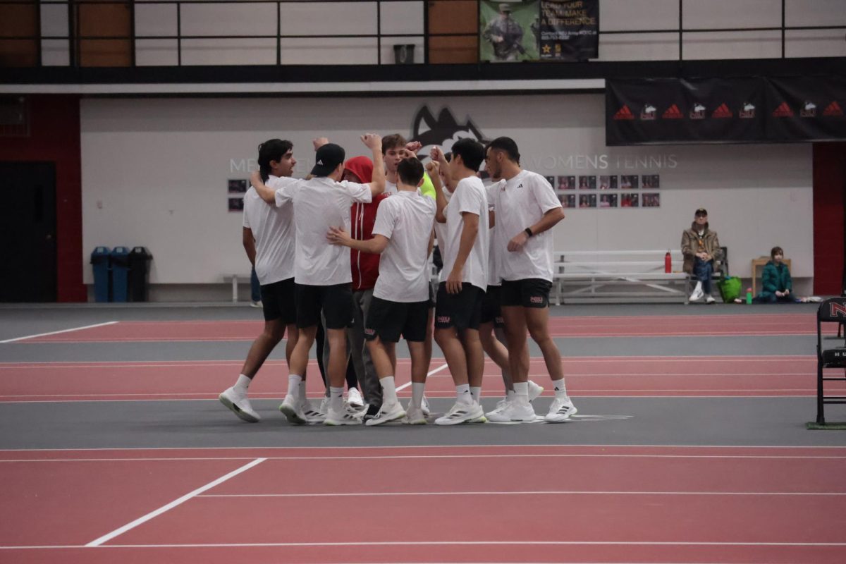 Members of the NIU men’s tennis team rally together before their match against Indiana University Indianapolis on Jan. 23. The Huskies defeated Ball State University in a 4-1 match on Saturday to round out the regular season. (Northern Star file photo) 
