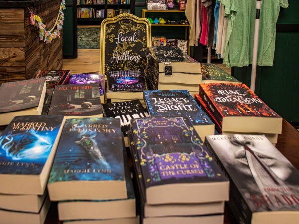 Books sit in the local author section of the Hidden Chapter Bookshop at 207 W. State St. Suite A in Sycamore. The book store is open 10 a.m. to 5 p.m. Tuesdays through Saturdays. (Marco Alvarez | Northern Star)