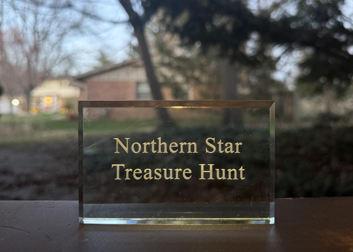 The Northern Star paperweight sits on a bench in front of a window. The Northern Star Treasure Hunt will begin April 6. (Brynn Krug | Northern Star)