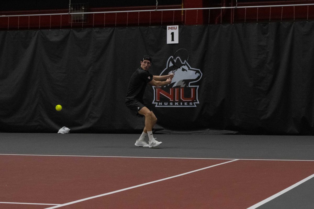 NIU men’s tennis sophomore Nikola Puntaric prepares a backhand groundstroke during his singles match against the University at Buffalo on March 19.  Puntaric was the clinching point in NIU’s win against the University of Toledo on Saturday, earning the Huskies a bid to the Mid-American Conference Championship. (Northern Star file photo)
