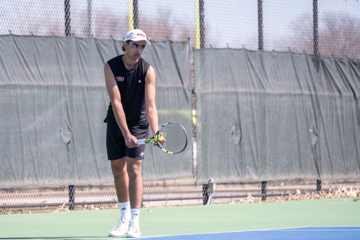 NIU men’s tennis sophomore Pratyaksh LNU prepares to serve the ball during his singles match against University at Toledo senior Matias Olivero on April 4. The Huskies lost to the University at Buffalo in the Mid-American Conference title match, falling 4-0 to the Bulls. (Totus Tuus Keely | Northern Star)