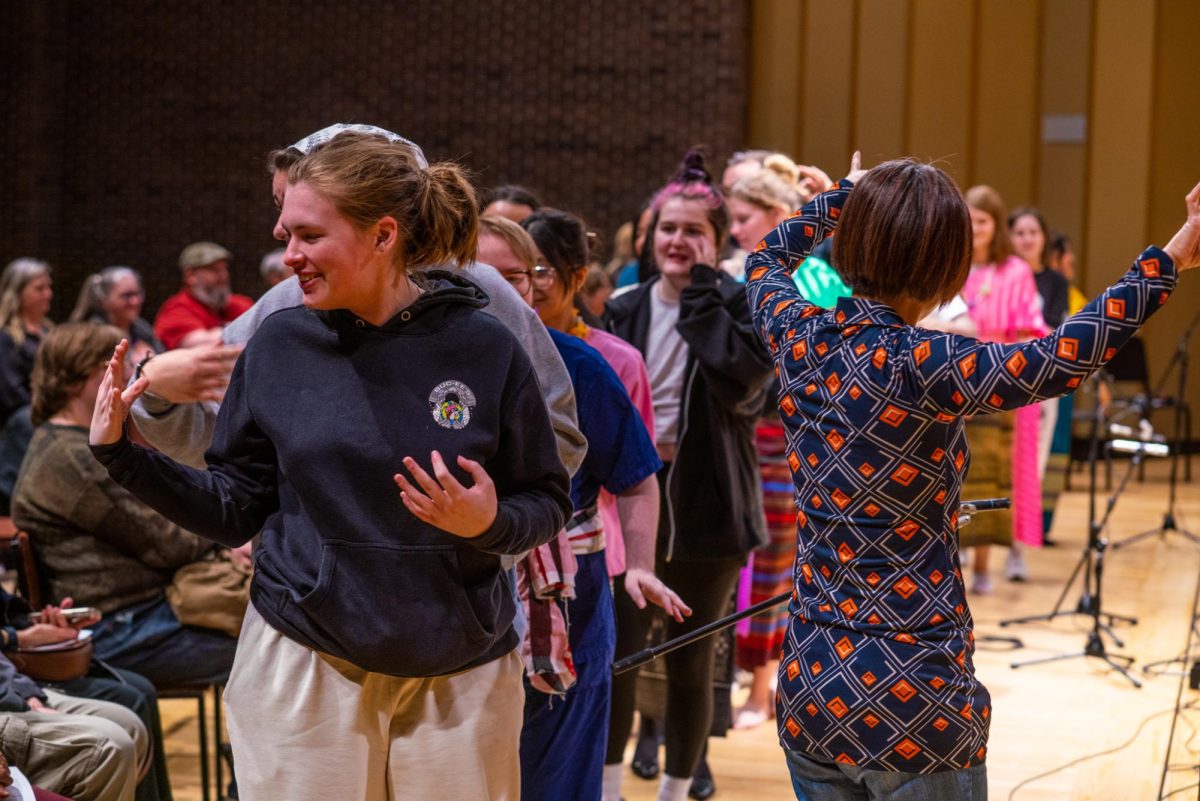 Audience members dance at the conclusion of the Music of Thailand performance on Tuesday in the Music Building, Boutell Memorial Concert Hall. Members of the audience were invited on stage to dance with performers at the end of the show as a sign of gratitude for watching the performances. (Eric McGill | Northern Star)