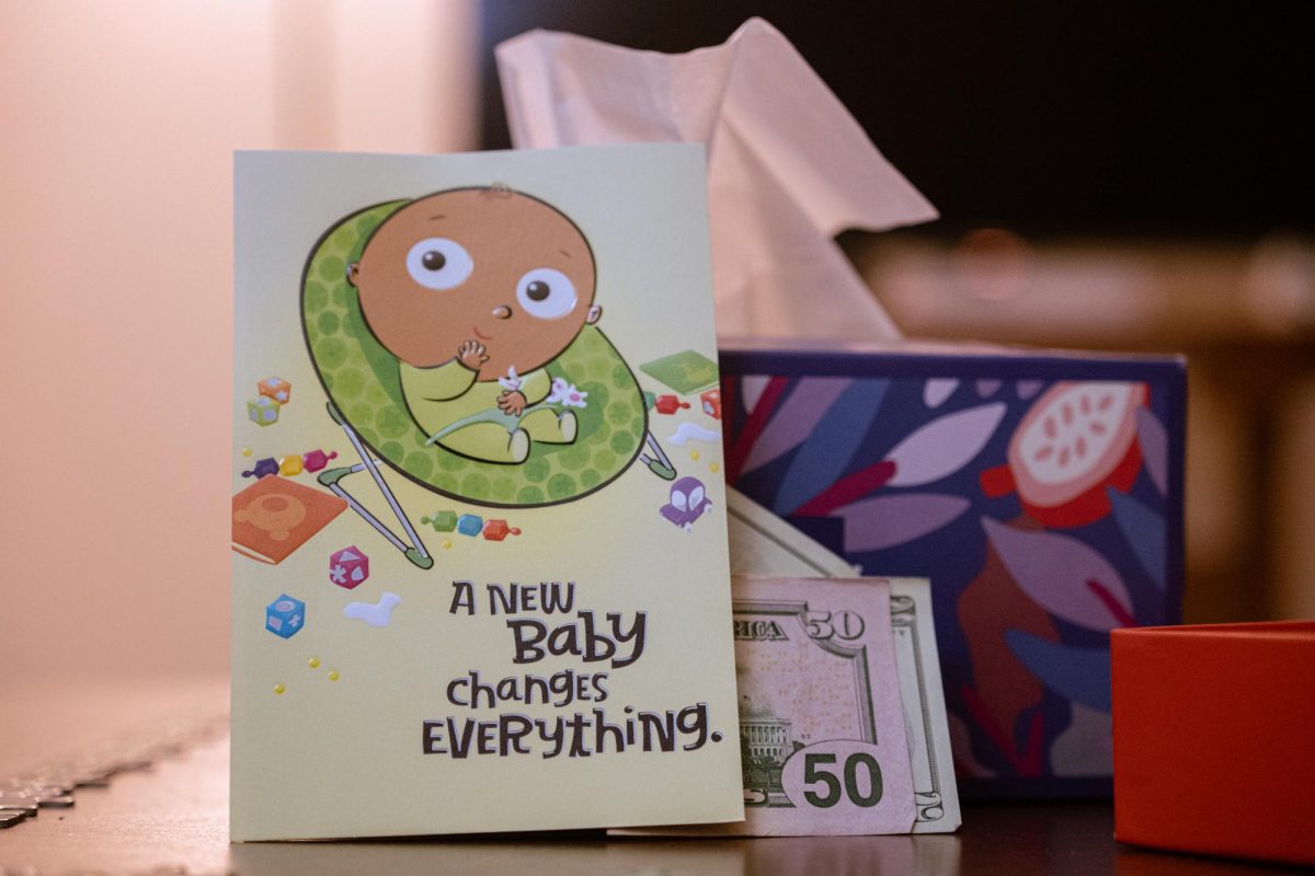 A pregnancy congratulations card leans against a box of tissues. Opinion Columnist Byrdie Seda believes the current socio-economic climate reinforces that it is OK to not have children. (Totus Tuus Keely | Northern Star)