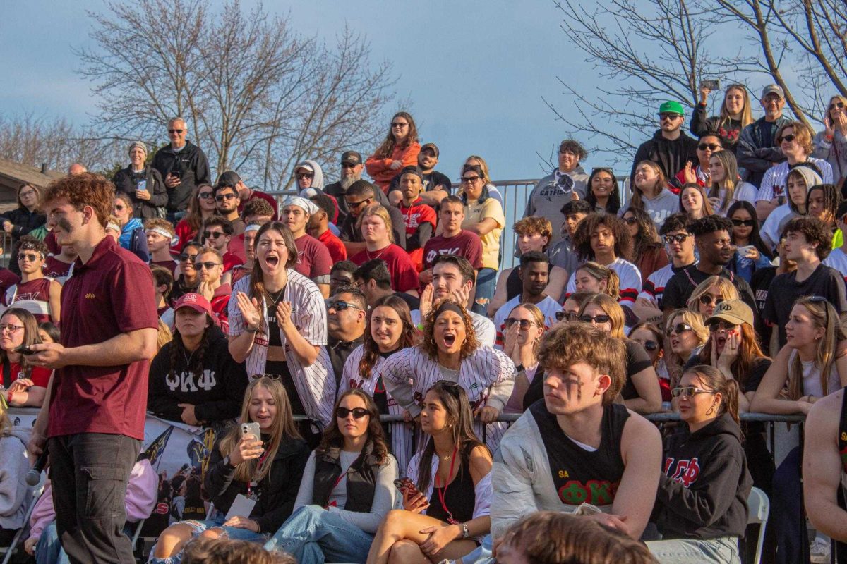 Phi Kappa Psi fans lean over the barriers to cheer on the Phi Psi tuggers during the championship match on April 13, 2025.  Matches for Tugs 2026 began on Sunday and will extend with matches at 5 p.m. and 7 p.m. Monday through Wednesday and Friday, with the championship match at 6 p.m. Saturday. (Northern Star File Photo)