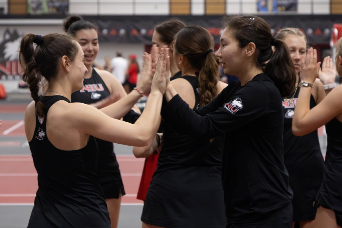 NIU women’s tennis sophomore Lucia Yecora (left) and senior Isabella Righi celebrate after winning a long rally during their doubles match against Ball State University seniors Sydney Hrehor and Asia Ting Fontana on Friday in the Chick Evans Field House. The Huskies ended their season with a 5-2 win over the Cardinals. (Sanaa Scott | Northern Star)