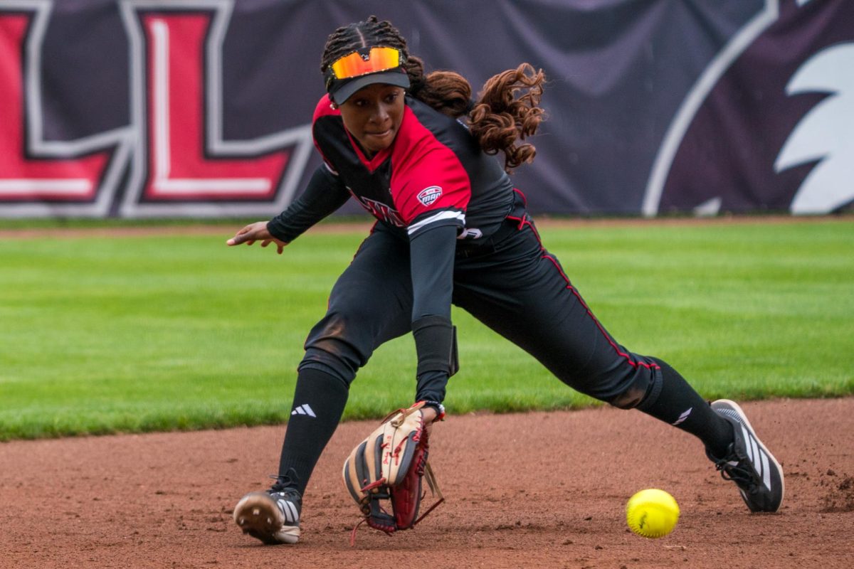 NIU softball junior shortstop Alana Powell makes a backhand play during NIU’s game against the University of Toledo on Friday.  Powell tied the record for most doubles in a game with three as the Huskies split a Saturday doubleheader against Toledo to end the regular season. (Eric McGill | Northern Star) 
